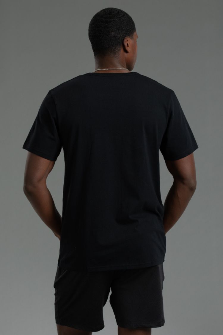 Person wearing a black t-shirt and shorts on a gray background || black