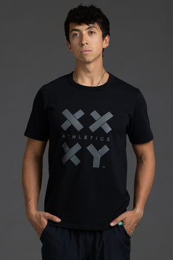 Person wearing a black t-shirt with a logo and text on a gray background || Black Tonal