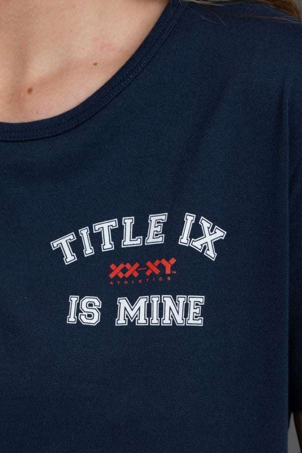 Navy blue t-shirt with 'TITLE IX IS MINE' text on a person wearing it. || Navy