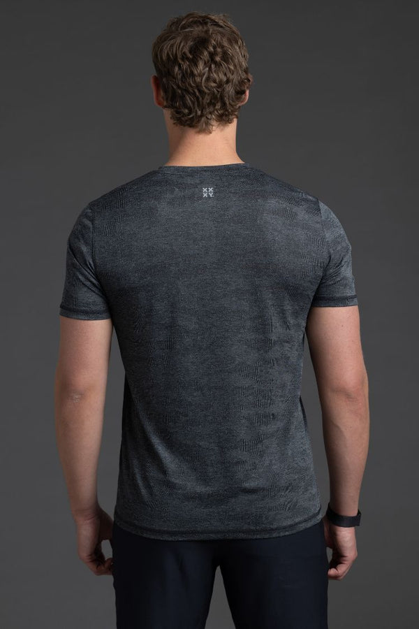 Man wearing a dark gray t-shirt against a gray background || Black