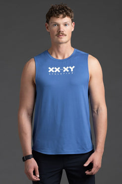 Man wearing a blue sleeveless shirt with 'XX-XY Athletics' logo on a gray background || Cobalt Blue