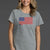 Woman wearing a gray t-shirt with an American flag design || Heather Gray
