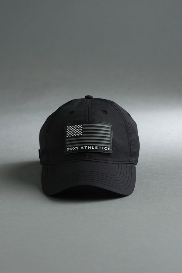 Black cap with American flag patch and 'XX NY Athletics' branding on a gray background || Black