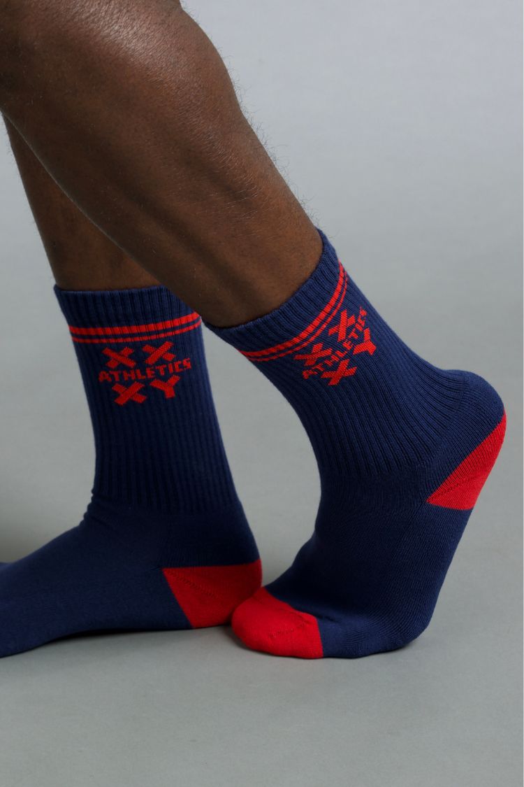 Navy and red socks with a brand logo on a neutral background || blue aster/red