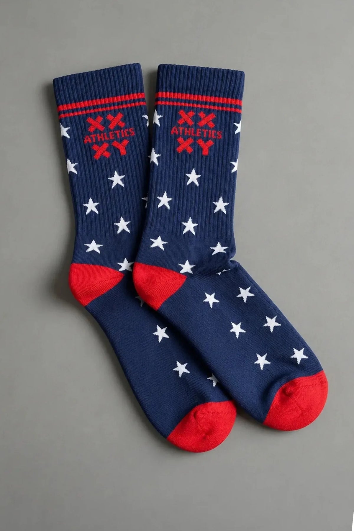 Navy XX-XY Athletics crew socks with white stars, red accents, and red toes on a gray background. || patriotic with stars