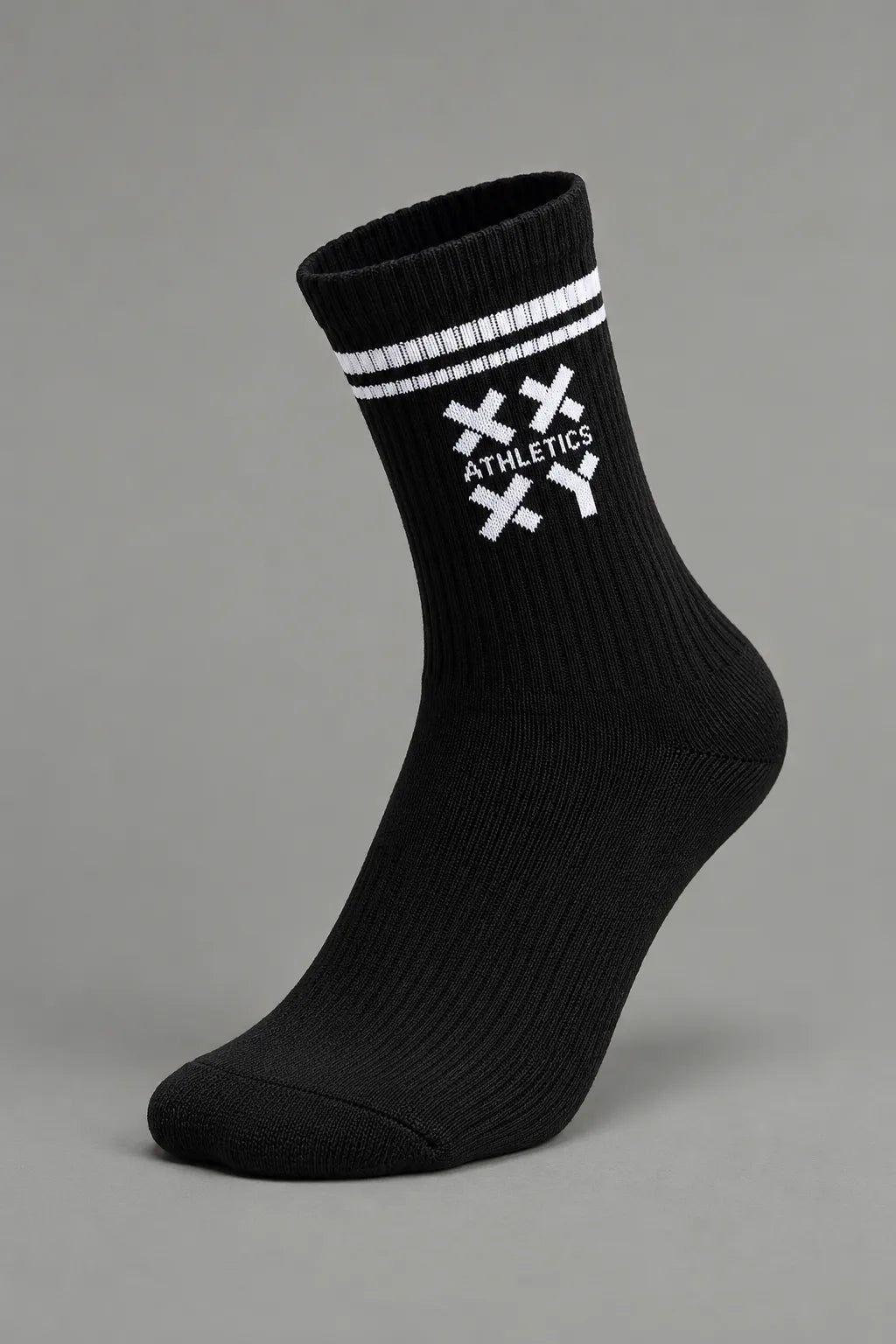 A single black crew sock with white stripes and a white crossed-knife logo featuring the word 'ATHLETICS' on the side, shown against a solid gray background.