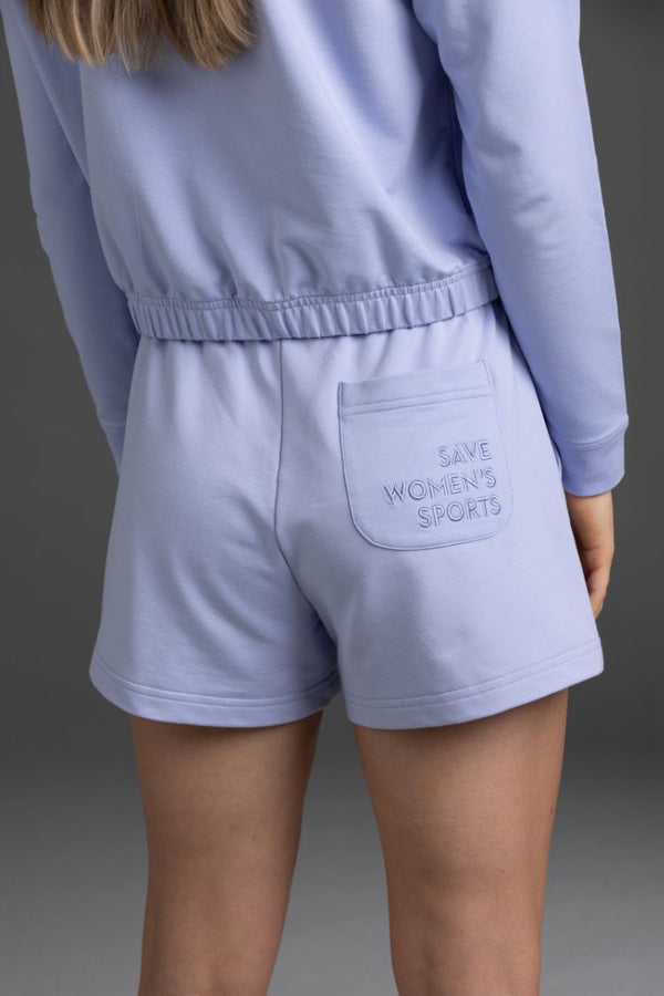 Person wearing a Lavender Gray outfit with 'Save Women's Sports' shorts || Lavender Gray