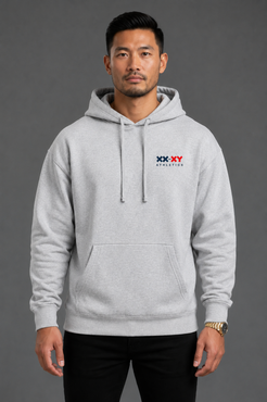 A man wearing a light gray heather pullover hoodie with a small red, white, and blue 'XX-XY AFFECTION' chest graphic, posed against a solid dark gray studio background. || Heather Gray