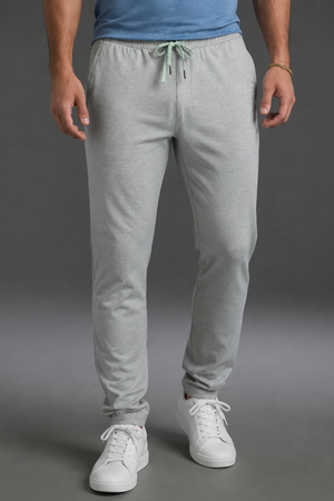 Person wearing gray sweatpants and white sneakers on a gray background || Light Heather Gray - 1