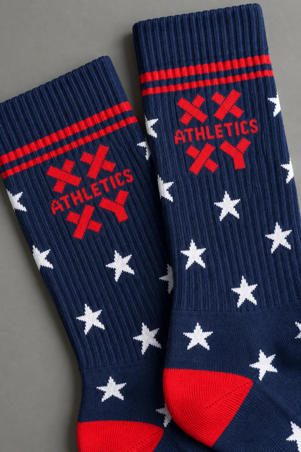 Zoomed in shot of navy XX-XY Athletics crew socks with white stars and red accents || patriotic with stars