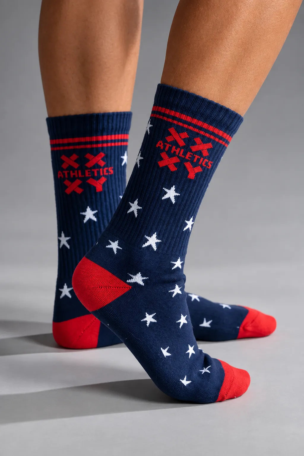 Navy blue socks with red and white patterns on a gray background