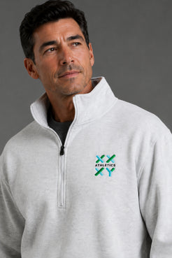 Male model wearing a light gray XX-XY Athletics quarter-zip fleece, shown in a close-up studio shot highlighting the embroidered chest logo. || Light Heather Gray