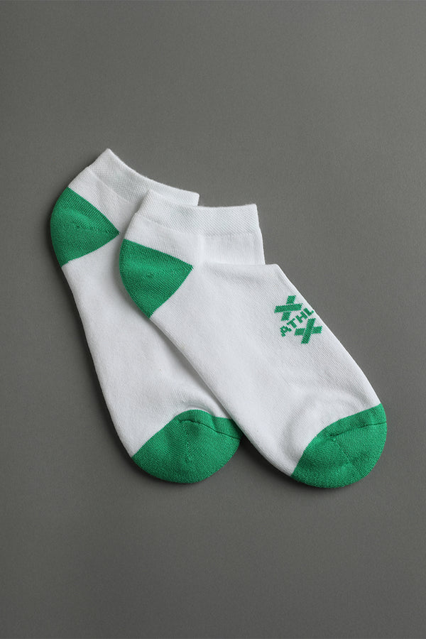White socks with green accents on a gray background || white