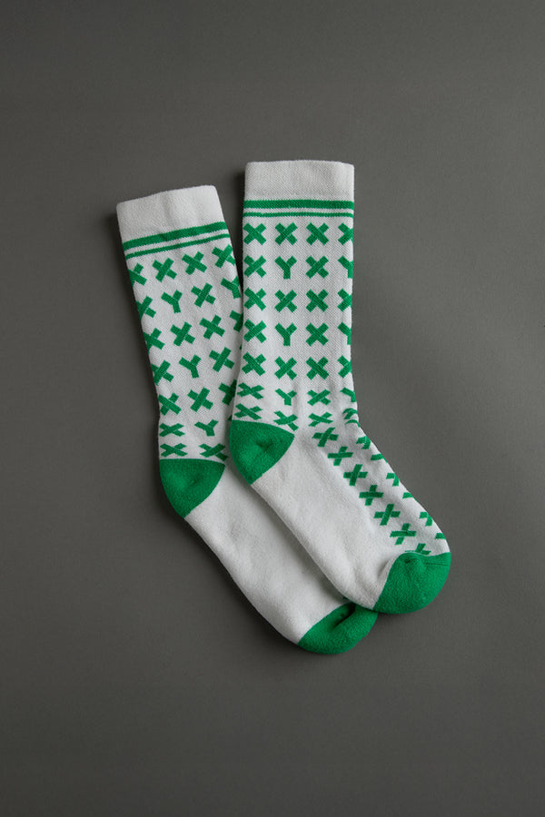 Pair of white socks with green pattern on a gray background || kelly green