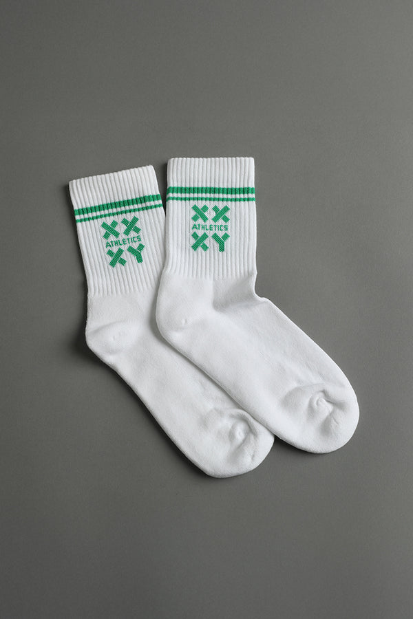 White socks with green stripes and logos on a gray background || white