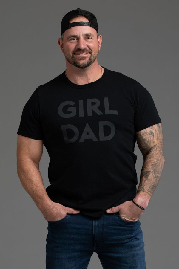 Man wearing a black t-shirt with 'GIRL DAD' text on a gray background || black
