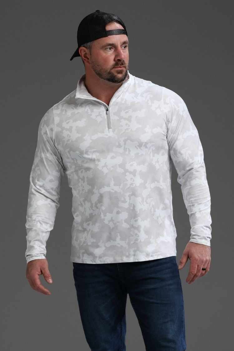 Man wearing a white camouflage pullover and dark jeans on a gray background || white camo