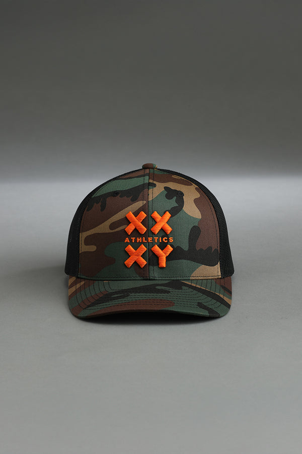 Camouflage cap with orange logo on a gray background || camo