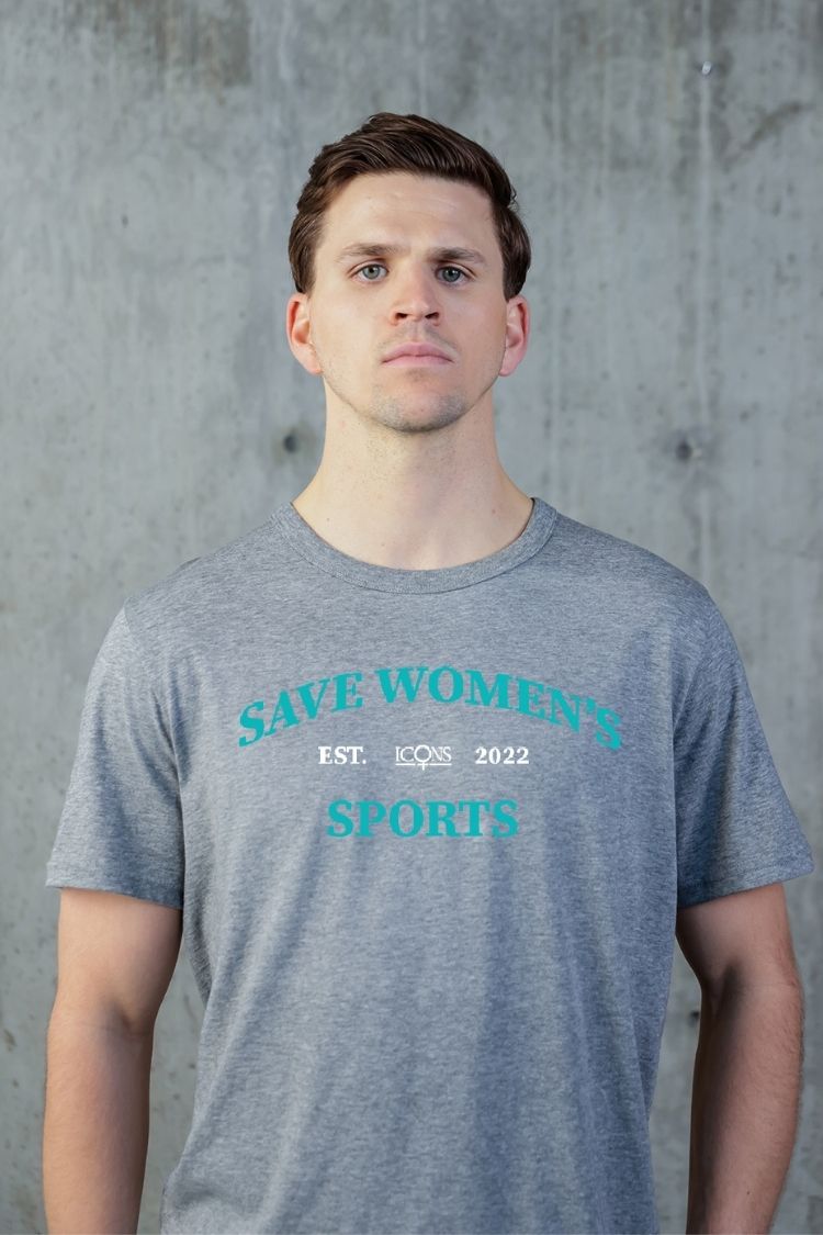 Man wearing a gray t-shirt with 'Save Women's Sports' text against a concrete wall. || heather gray