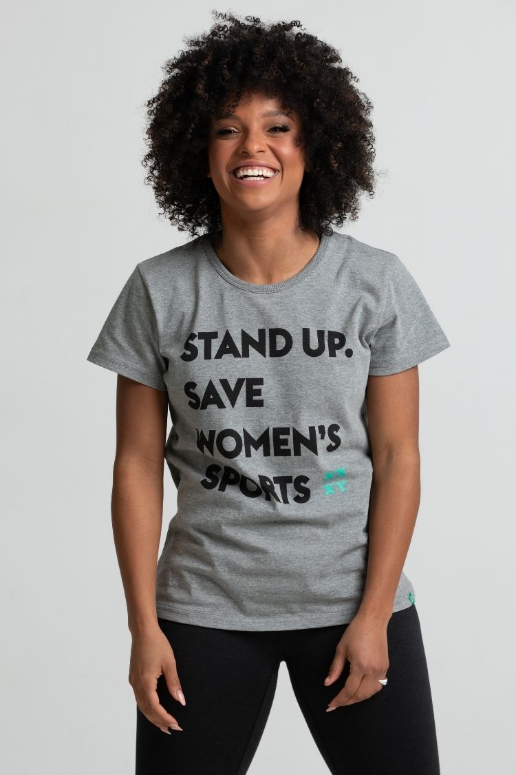 Person wearing a gray t-shirt with text on a plain background