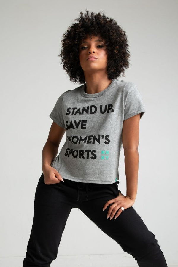 Person wearing a gray t-shirt with text on a plain background