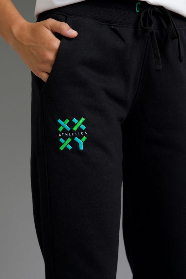 Black pants with a green and blue logo on a gray background || Black