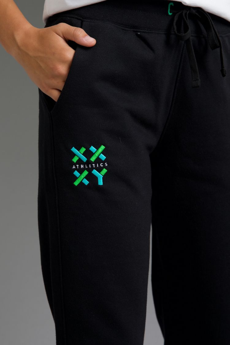 Black pants with a green and blue logo on a gray background || Black