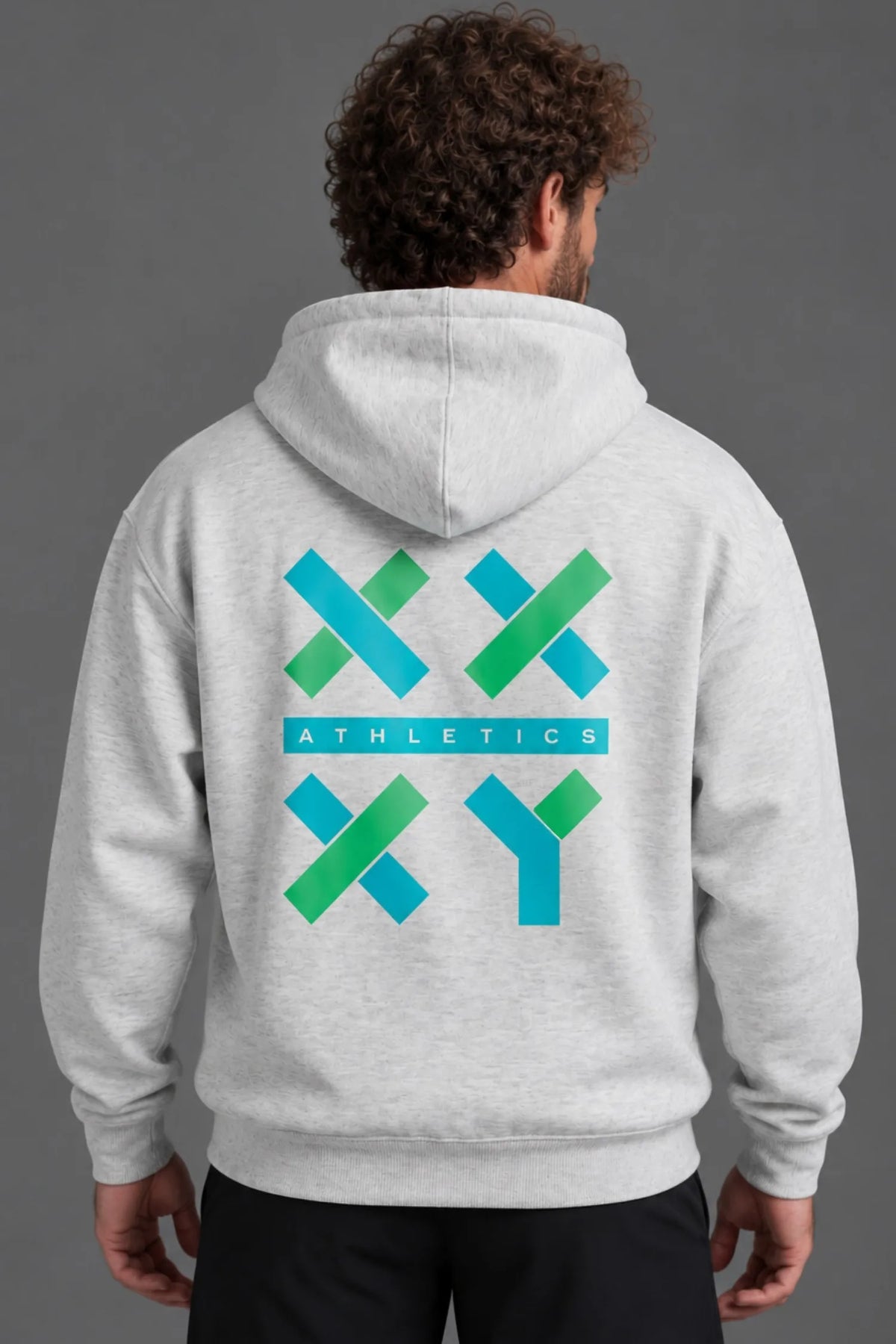 Back view of male model wearing a heather gray hoodie featuring the large teal and green XX-XY Athletics graphic. || Light Heather Gray