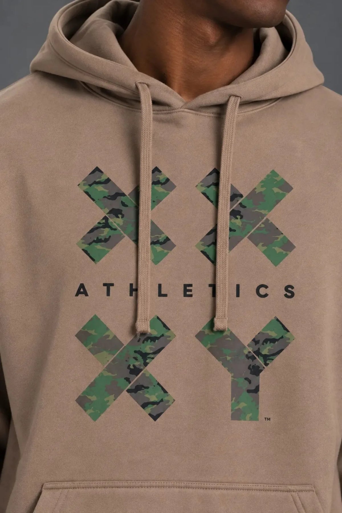 Close-up of the camouflage XX-XY Athletics graphic on a mocha pullover hoodie.