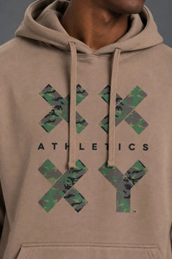 Close-up of the camouflage XX-XY Athletics graphic on a mocha pullover hoodie. || mocha