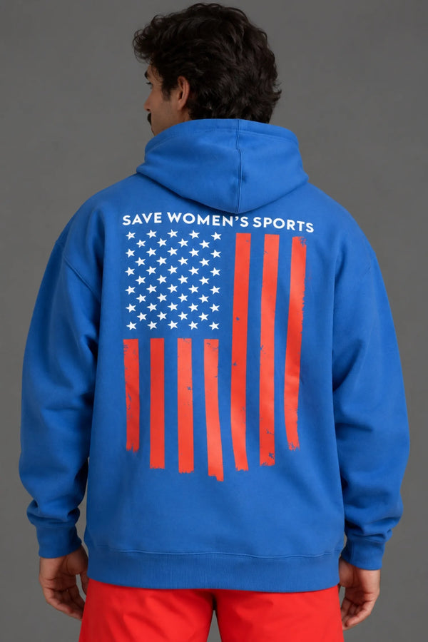 Back view of male model wearing a blue hoodie with a distressed American flag graphic and “Save Women’s Sports” text. || Cobalt Blue