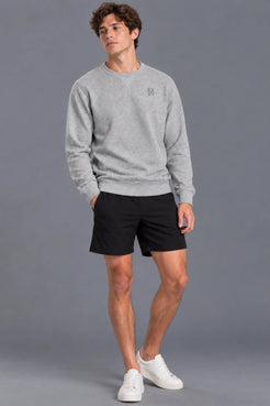 Male model smiling while wearing the XX-XY Athletics Crewneck Sweatshirt, black shorts and white sneakers || Heather Gray