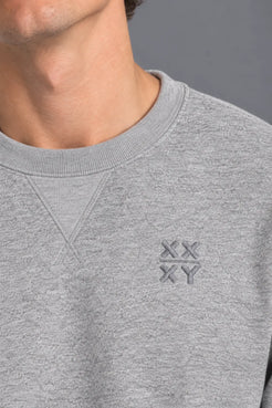Close-up of the XX-XY Athletics Crewneck Sweatshirt, highlighting the tonal embroidered XX-XY logo and heather gray French terry fabric || Heather Gray