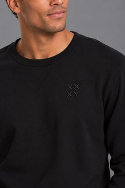 Close-up of the XX-XY Athletics Crewneck Sweatshirt, highlighting the tonal embroidered XX-XY logo and black French terry fabric || Black