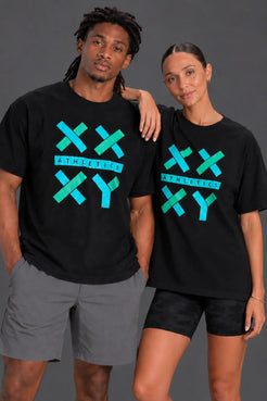 Two models wearing black XX-XY Athletics graphic T-shirts pose together against a dark gray studio background. || Black