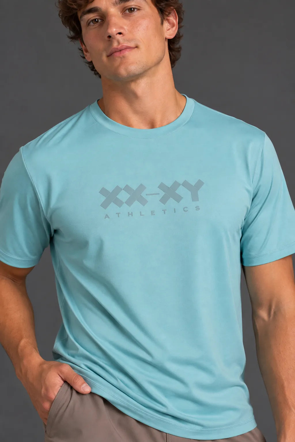 Male model wearing the light blue XX-XY Athletics Logo Tee with mocha shorts. || Underseas