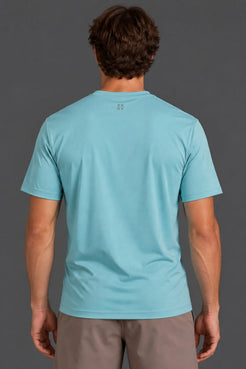 Back view of male model wearing the light blue XX-XY Athletics Logo Tee with mocha athletic shorts. || Underseas