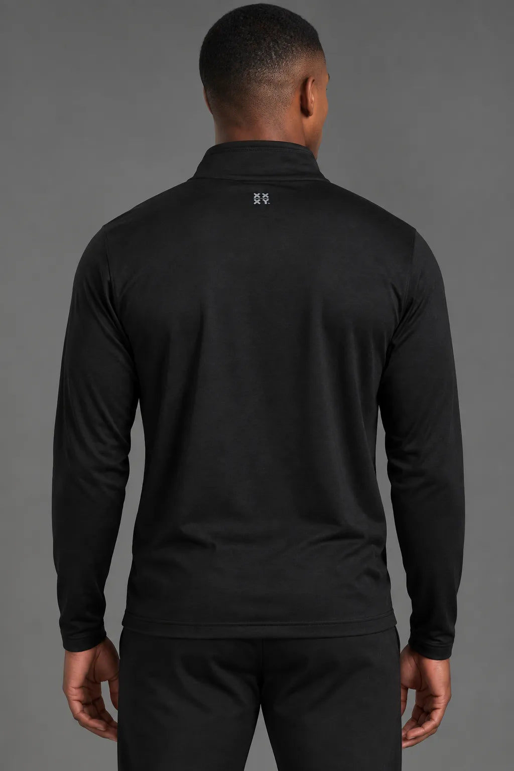 Back view of male model wearing the Men’s Black Quarter Zip, featuring the XX-XY logo below the collar. || Black