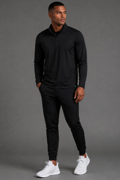 Male model wearing the Men’s Black Quarter Zip with matching black joggers.|| Black