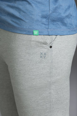Gray pants with a brand logo on the waistband against a gray background || Light Heather Gray - 1
