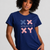 Person wearing a navy blue t-shirt with pink and white graphics on a plain background || navy