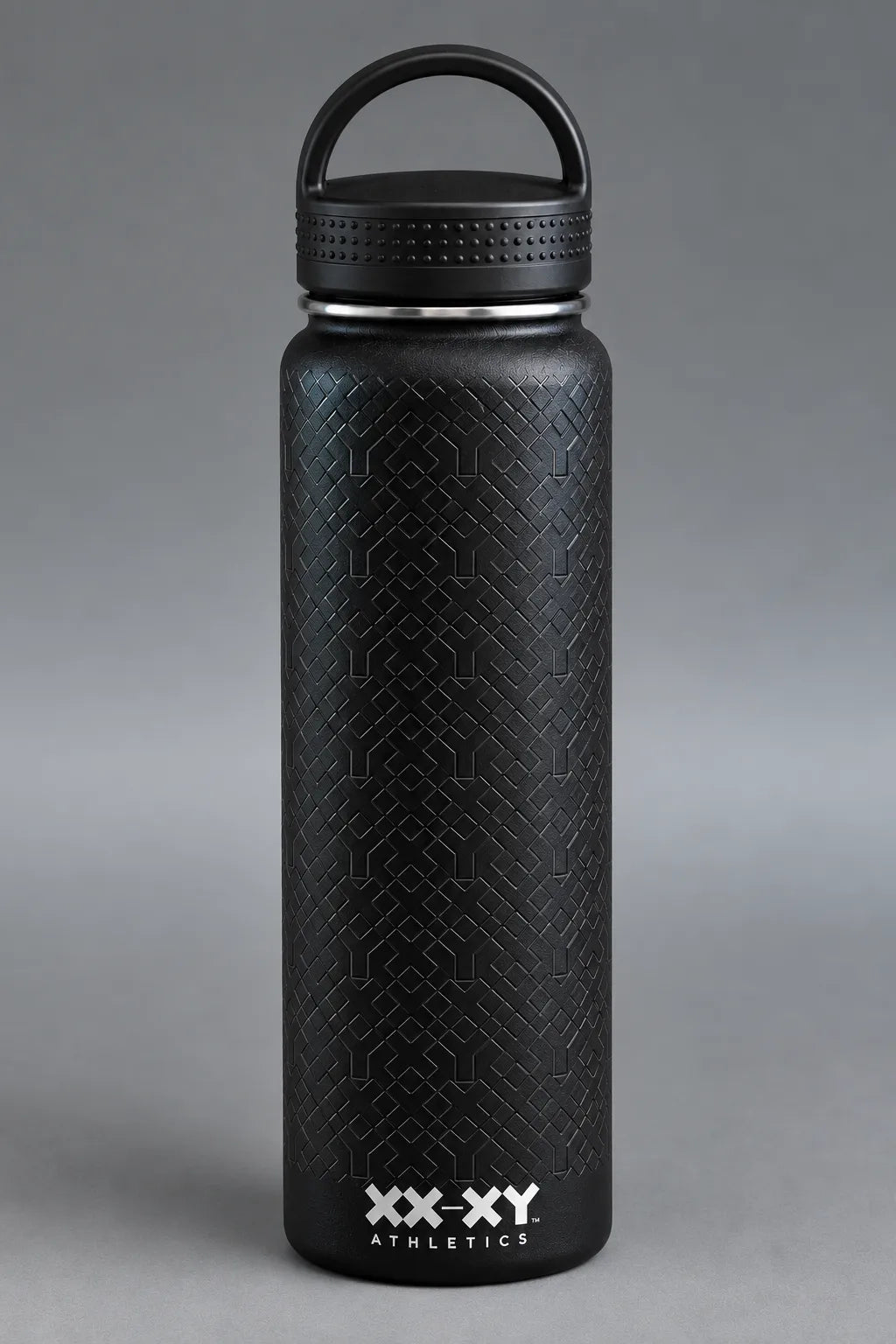 Black XX-XY Athletics water bottle with embossed geometric texture and loop handle lid on gray background