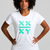 Person wearing a white t-shirt with green geometric designs on a gray background || White