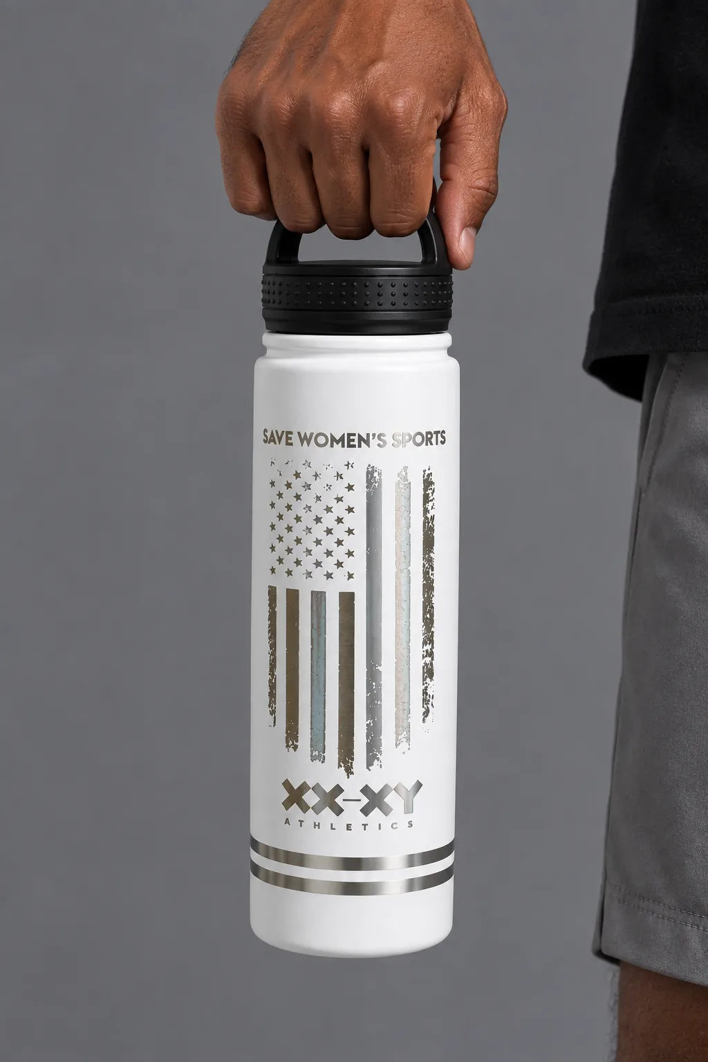 Male model holding the white XX-XY Athletics Save Women’s Sports water bottle by the lid. || White
