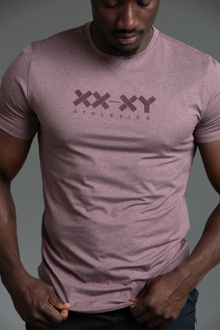 Person wearing a maroon t-shirt with 'XXXY Athletics' logo on a gray background