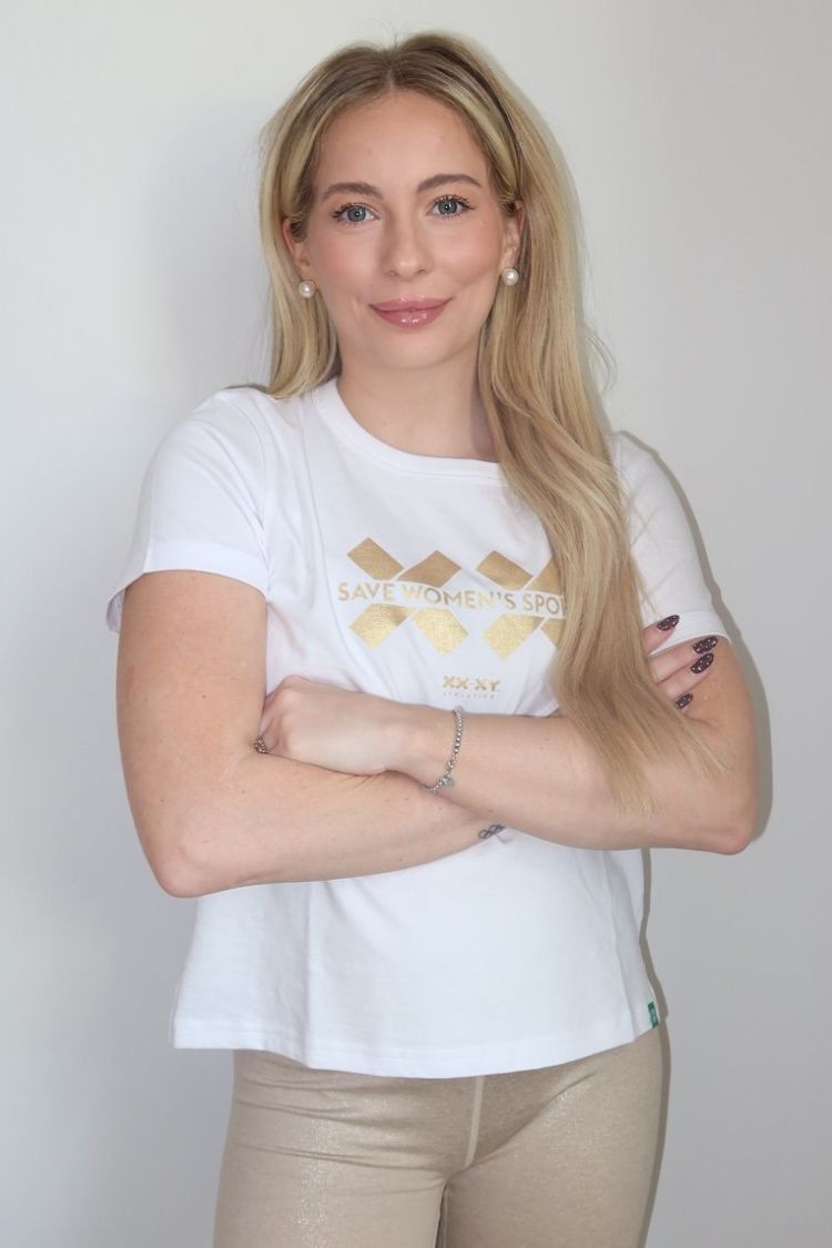 Woman wearing a white t-shirt with a logo on a plain background