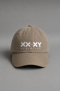A beige baseball cap with a white embroidered logo reading 'XX-XY ATHLETICS' on the front, photographed against a neutral gray background. || Mocha