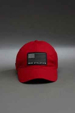 Red cap with a black patch on a gray background || red