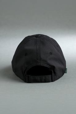Back view of a black adjustable baseball cap with a fabric strap and small XX-XY Athletics side tag. || Black