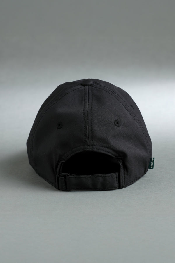 Back view of a black adjustable baseball cap with a fabric strap and small XX-XY Athletics side tag. || Black